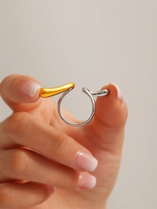 Detail of two-tone irregular line ring with gold and silver polished finish
