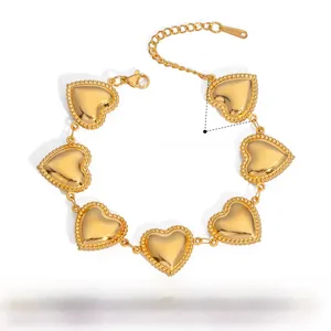 Detailed view of heart-shaped stainless steel bracelet with 23mm charms in gold finish