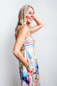 Detail of colorful tropical floral print and ruched side on a summer maxi dress
