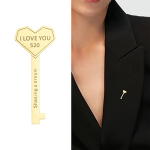 Golden heart key brooch with I Love You engraving on model and white background