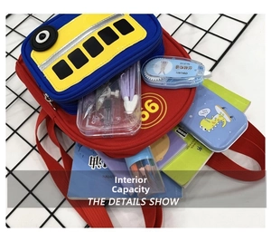 Internal capacity of the bus backpack showing stationery items like notebooks and pencils