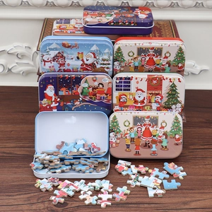 Close-up of 60-piece Christmas tin box puzzle with colorful Santa and snowman patterns
