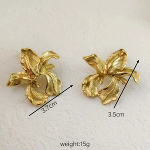 Detail showing 3.7cm gold flower earrings with brushed texture and weight dimensions