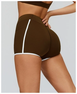 Detail view of high-waist yoga shorts with contrast trim and lifting seam for fitness