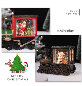 Detail of vintage Christmas train lanterns with glowing LED light and festive figurines