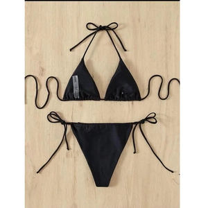 Flat lay of black triangle bikini set with tie-side bottoms and textured quick-dry fabric