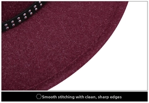Detail of wool fedora with black ribbon trim and silver metallic studs decoration