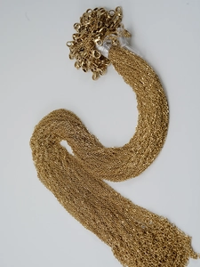 Detailed macro view of bulk 18K gold-plated stainless steel cross chains with lobster clasps
