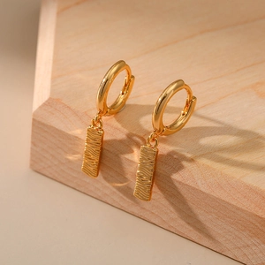 Detail of 18K gold-plated earrings with rectangular water ripple textured pendants
