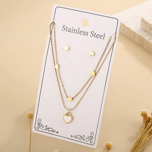 Detail of double-layer heart necklace and earrings set on white display card