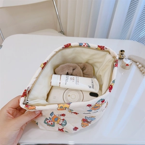 Internal view of a quilted cotton floral makeup bag showing ample storage space