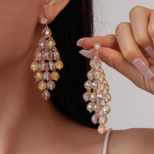 Detail of gold fringe earrings with rainbow crystals shown on model and in hand