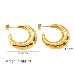 Detail view of gold C-shaped hollow tube earrings with size 2.6cm diameter and 0.8cm width