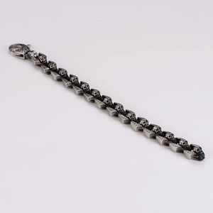 Macro view of retro skull links and lobster clasp on stainless steel bracelet