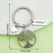Detail of silver family tree keychain with heart charm and size measurements in inches