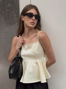 Elegant ivory satin spaghetti strap top with peplum hem and sleek square neckline