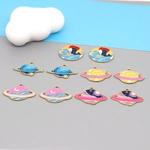 Detailed view of colorful enamel space pendants featuring whale and planet designs