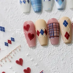 Detail showing 5D embossed nail stickers with heart and argyle patterns on display nails