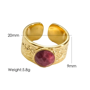 Detailed specs of vintage gold titanium ring with red gemstone and engraved band
