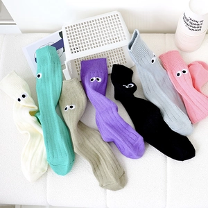 Flat lay of cotton crew socks in multiple candy colors with cute big eye embroidery