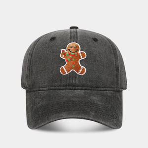 Detail of embroidered gingerbread man on washed black vintage cotton baseball cap