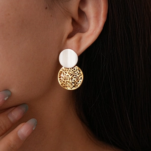 Detail of 18k gold plated geometric hollow round earrings worn by a female model