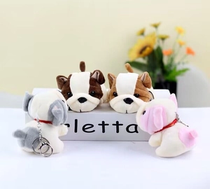 Adorable plush French Bulldog keychains in four colors arranged on a white gift box