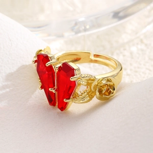 Detail shot of the red coffin zircon with ornate rose accents on the golden open ring