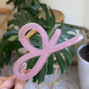 Pink translucent bow-shaped hair claw clip with gold spring for women hair styling