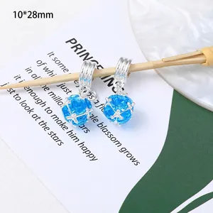 Macro shot of 10x28mm blue bead pendant with snowflake metal cage on wooden stick