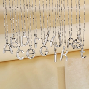 Polished silver titanium steel alphabet pendant necklace collection with cubic zirconia inlay