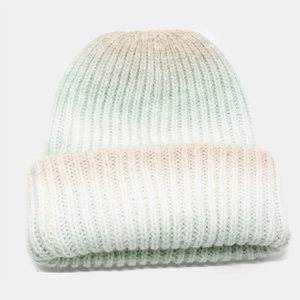 Detail of soft ribbed knit texture on a winter hat with pastel green gradient colors