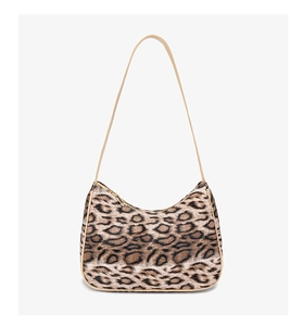 Detail view of leopard print crescent shoulder bag featuring beige trim and golden zipper