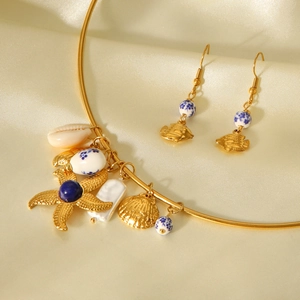 Detailed shot of ocean-themed necklace with starfish, shell pendants and ceramic beads