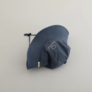 Close-up of lucky embroidery and smiley face on quick-dry sun hat with adjustable cord