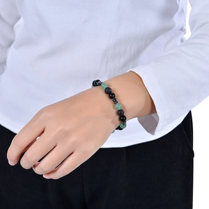 8mm natural green crystal and black volcanic stone beaded bracelet on model's wrist