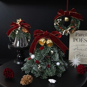 Handmade mini Christmas tree ornaments and glass bell decor on a black background