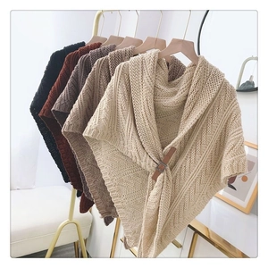 Detail of knitted triangle shawl cardigan with adjustable leather buckles in multiple colors
