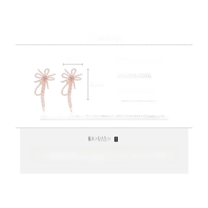 Detail view of pink crystal beaded bow earrings with size labels 11cm by 7cm