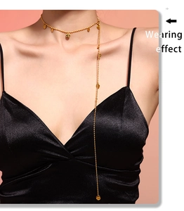 Effetto indossato di una collana con nappine a dischi dorati su un abito di raso