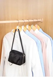 Space-saving plastic hanger connectors in pastel colors for organized closet storage