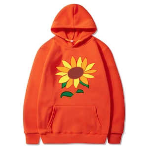 Detail of orange drawstring hoodie featuring hand-drawn sunflower print and kangaroo pocket