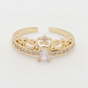 Macro view of gold crown ring featuring an oval center zircon and small side diamonds