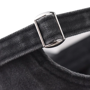 Detail of adjustable metal buckle and washed cotton texture on vintage baseball cap