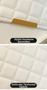 Detail of white quilted handbag featuring gold metal hardware and fine leather texture