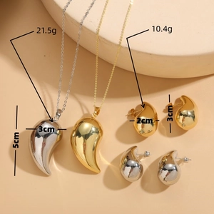 Polished gold and silver teardrop jewelry set featuring a chunky necklace and earrings