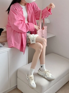 Close-up of pink and white heart-patterned breathable cotton socks on models' feet