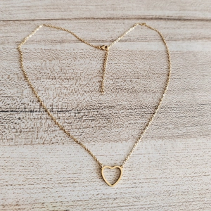 Minimalist 18k gold heart necklace featuring a hollow heart pendant on a delicate O-chain