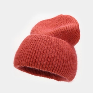 Close-up of rust red angora rabbit hair knit hat with thick ribbed texture and soft fur fibers
