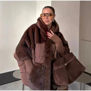 Close-up of faux fur and quilted fabric splicing detail on a dark brown winter jacket